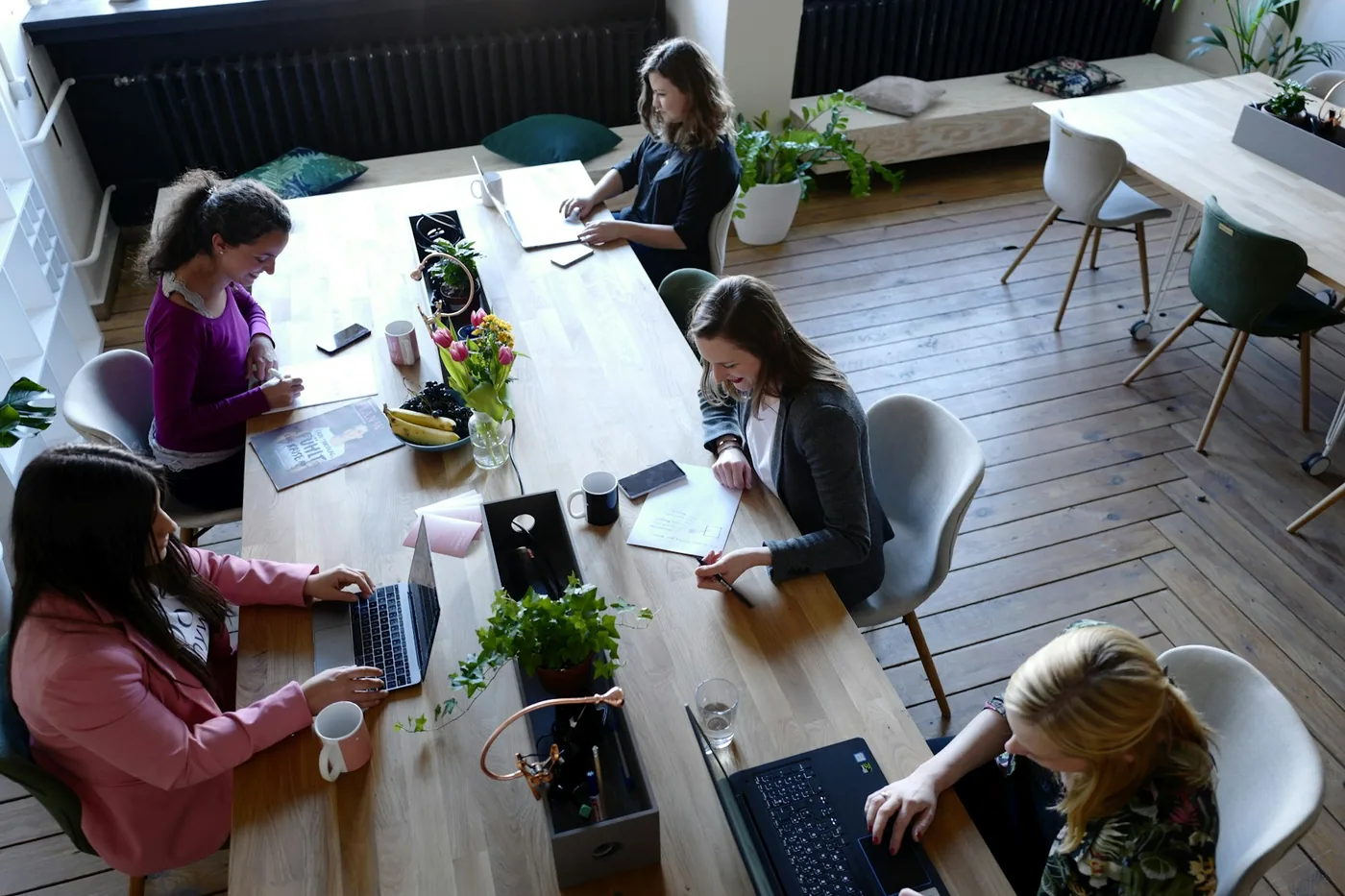 Colleagues working together around a shared table, seen from above